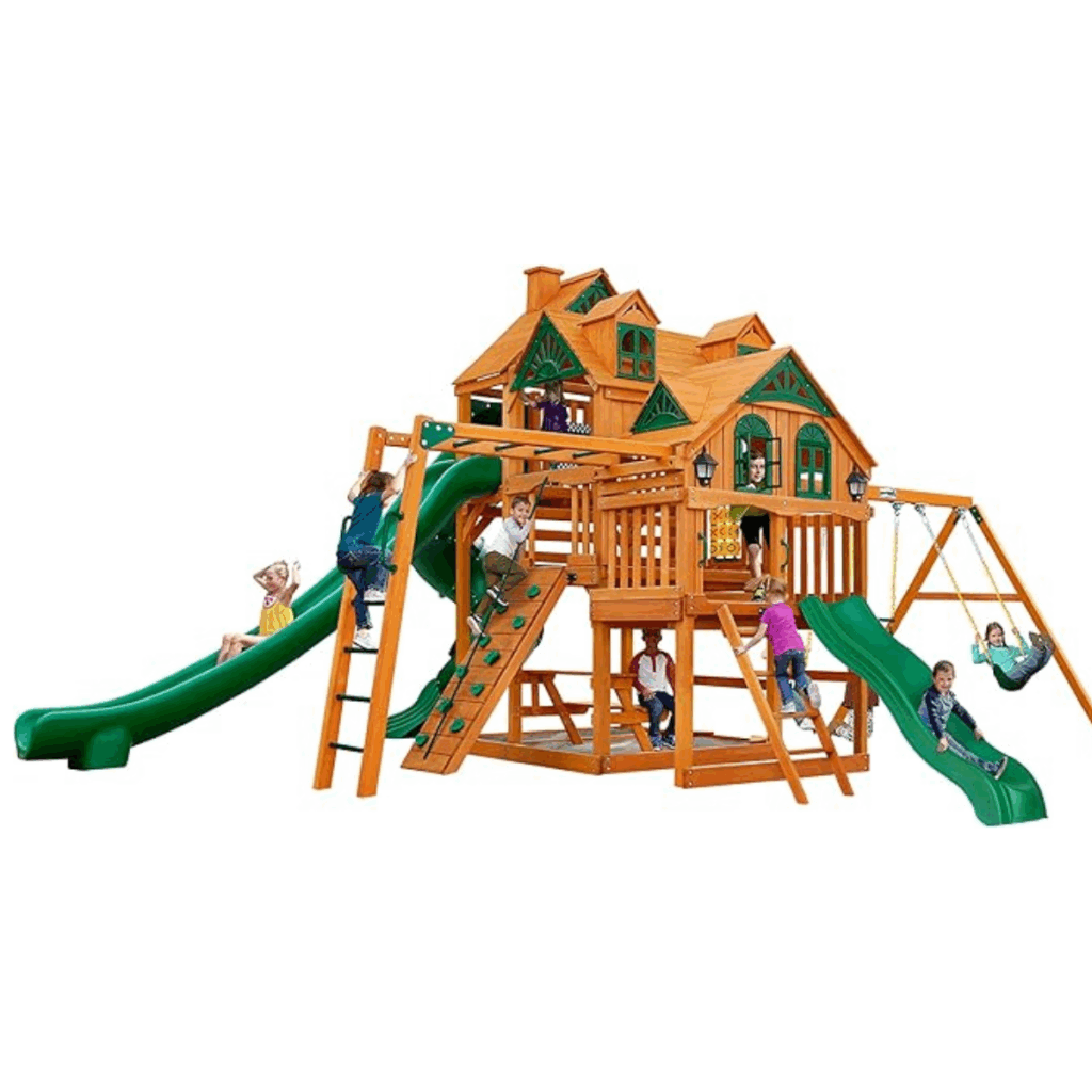 Children play on a Gorilla Playsets Empire Extreme Wooden Swing Set with monkey bars, clatter bridge, tower, and 3 slides. This large structure has a clubhouse that resembles a house with windows, balcony, swings, climbing wall, and ladders.